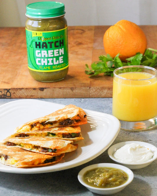 Quesadilla with a jar of chopped chile co hatch green chile in the background