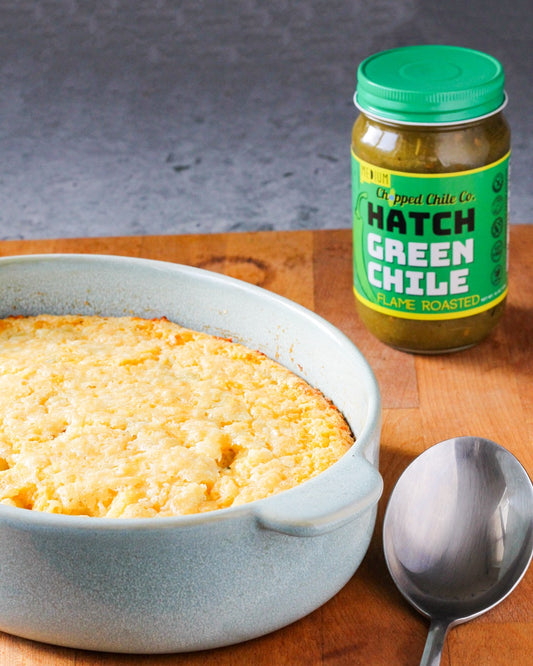 Jar of hatch green chili by chopped chile co next to cheddar cheese bread